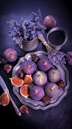 figs and flowers on a plate with a knife