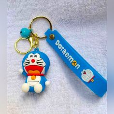 a keychain with a cartoon character on it next to a blue toothbrush