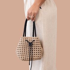 Get ready to weave your way through the day (literally) with our Espresso Weave Mini Tote. Perfect for all your essentials, this hand woven bag features an adjustable opening and an inside pocket for easy organization. Plus, the attachable straps offer versatile and comfortable carrying options. It's everything you need to stay chic and organized, all in one quirky and cute tote! hand woven bag with adjustable opening fully lined Inside pocket Attachable straps Dimensions: H 7" | W 7" | D 5" Dimension do not include purse strap Handheld Shoulder Bag With Intrecciato Weave For Travel, Versatile Bucket Bag Tote With Braided Handles, Casual Handheld Woven Bucket Bag, Everyday Braided Bucket Bag, Trendy Braided Bags For Daily Use, Summer Rectangular Bucket Bag With Intrecciato Weave, Natural Bucket Bag With Intrecciato Weave, Casual Crochet Pouch Bag With Braided Handles, Rectangular Braided Bag For Everyday