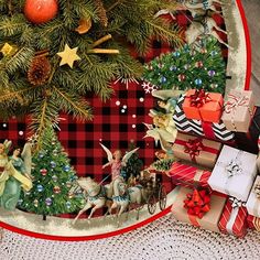 a christmas tree surrounded by presents and other holiday decorations on a tablecloth covered plate