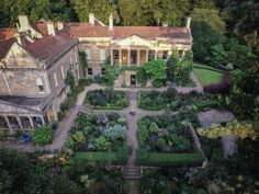 an aerial view of a large house surrounded by trees and bushes with lots of greenery