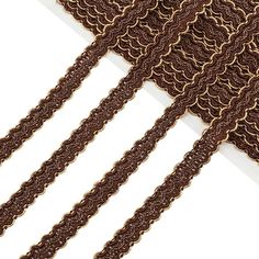 a close up of a tie on a white surface with brown lines in the background