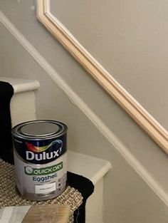 a can of duluxx is sitting on the stairs