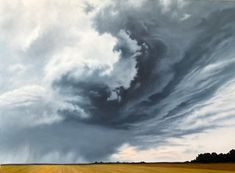 a large field that has some clouds in the sky