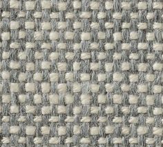 the texture of an upholstered fabric with white and gray squares on it's surface