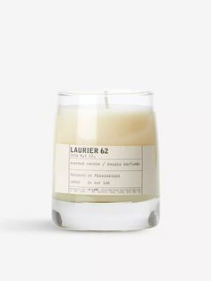 a candle that is sitting on top of a white surface with the words, laurier 6