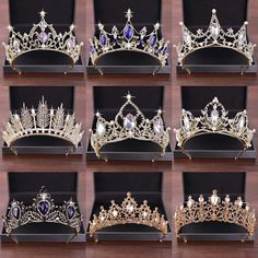 six different tiaras in black boxes on a wooden table with white and blue stones