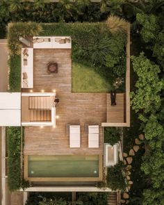 an aerial view of a house with a pool and decking area in the backyard