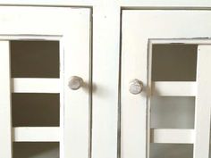 two white cupboards with one door open and the other closed