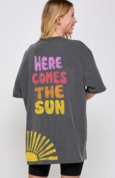 This oversized, casual t-shirt features a fun and colorful design with the bold text "HERE COMES THE SUN" printed in gradient tones of pink, orange, and yellow. The back of the shirt also includes a vibrant yellow sun graphic, adding an extra pop of brightness. Made from soft, comfortable fabric, this shirt has a relaxed fit, perfect for lounging or pairing with casual outfits like biker shorts or jeans. Highlights: Bright, uplifting design: The retro-inspired text and sun graphic give a cheerfu Sun Graphic, Striped Bags, Fashion Bottoms, Bold Text, Yellow Sun, Here Comes The Sun, Turkish Towels Beach, Orange And Yellow, Colorful Design