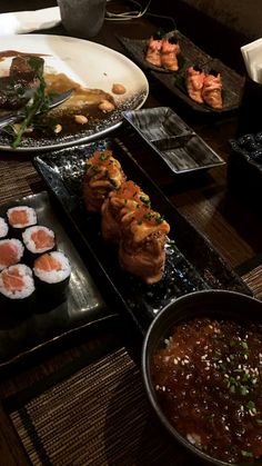 sushi and other foods are on the table ready to be eaten at this restaurant