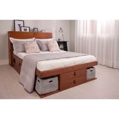 a bed with two storage baskets underneath it