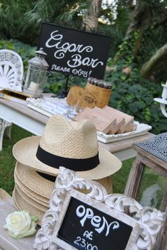 a table topped with lots of hats and signs