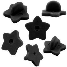 six black plastic buttons with holes in the middle and one star on each side, all facing different directions