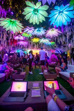 people sitting on couches with laptops in front of them at an outdoor event