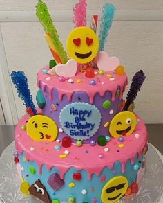 a birthday cake decorated with smiley faces and candies