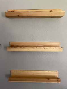 three wooden shelves mounted to the wall