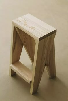 a small wooden stool sitting on top of a floor