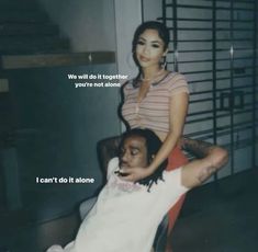 a woman sitting on top of a man in a chair