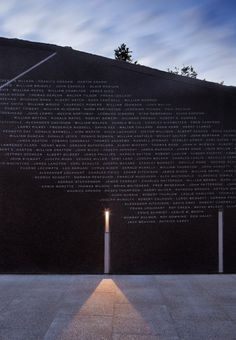 the shadow of a light shines in front of a wall with writing on it