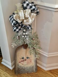 a christmas decoration hanging on the wall next to a door with a snowman ornament