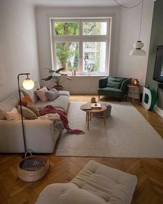 a living room filled with furniture and a flat screen tv sitting on top of a wooden floor