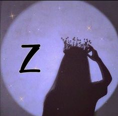 the silhouette of a woman with a crown on her head is in front of a full moon