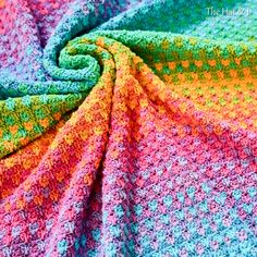 a crocheted blanket that is multicolored