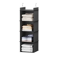 the four tiered shelf has folded clothes and folded towels on it's sides