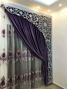 the curtains are open and ready to be hung in front of the window with purple flowers on