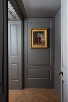 an empty hallway with a painting on the wall