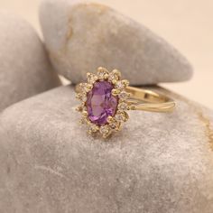 "This princess Diana ring features a natural oval cut amethyst in a halo ring surrounded by natural diamonds. This vintage Diana ring has simply an amazing contrast of colors, the purple and the gold together are simply beautiful! Perfect as an engagement ring, anniversary gift, statement ring and just as a stacking ring. * Center Stone: Clear Amethyst 7.00 x 5.00 m\"m (Approx 0.7ct) * Side Diamonds: 0.20ct, 14 Pieces * Bottom Band Thickness: 2.35 m\"m * Material: High Quality Solid Gold 14k/18k Luxury Timeless Purple Rings, Luxury Timeless Amethyst Wedding Ring, Gold Ring Purple Stone, Luxury Classic Oval Amethyst Ring, Luxury Oval Amethyst Birthstone Ring, Purple Engagement Ring Vintage, Purple And Gold Ring, Purple Diamond Ring Engagement, Purple Stone Engagement Rings