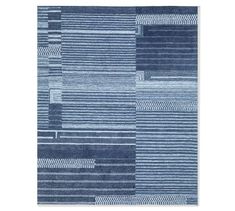 a blue area rug with squares and lines on the bottom, along with a white background