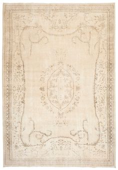 an antique rug is shown in white and beige with intricate designs on the border,