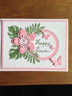 a handmade card with pink flowers and green leaves on the front, which reads happy easter