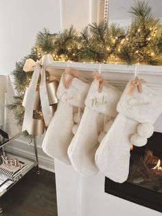 christmas stockings hanging from a mantel over a fireplace