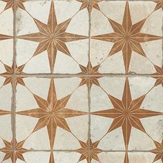 a tile floor with brown and white star designs on the top, in different sizes