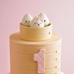 a cake decorated with three little white eggs