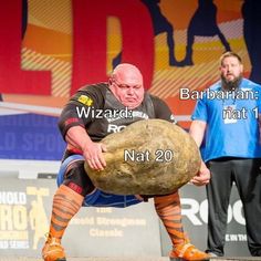 a man squatting down on a large rock in front of two men standing behind him