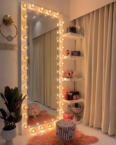 a mirror that has lights on it in front of a shelf with a stool and potted plant