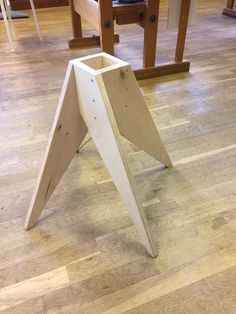 a wooden table that has some kind of triangular design on it, sitting in the middle of a room