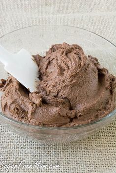 a scoop of chocolate ice cream in a glass bowl