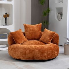 a living room with an orange chair and bookshelves