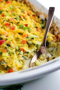 a casserole dish with broccoli, carrots and other vegetables in it