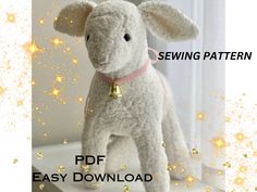 a white stuffed animal with a bell on it's neck and the words sewing pattern