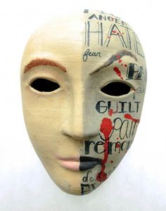 a white mask with words painted on it