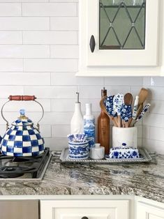 the kitchen counter is clean and ready to be used as a tea pot, sugar shaker, and other cooking utensils