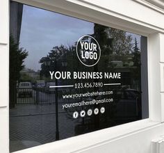 a business sign is reflected in the window of a building