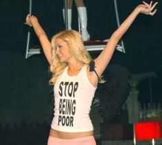 a woman is standing on a trampoline holding her arms up in the air