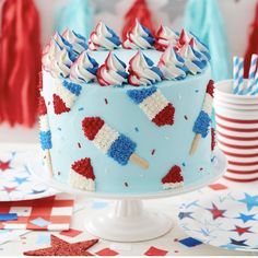 a patriotic cake with red, white and blue icing on it sitting on a table